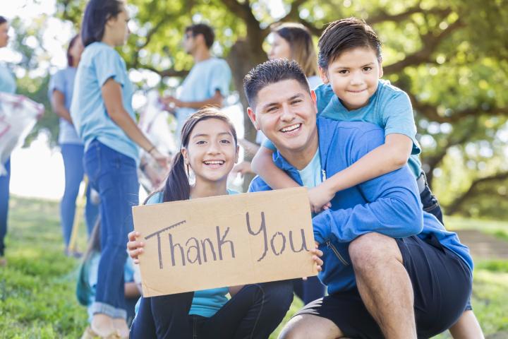 Family with thank you sign